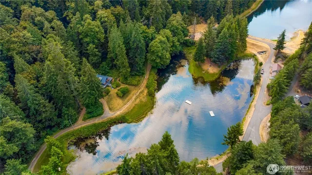 an aerial view of a house with a yard and swimming pool