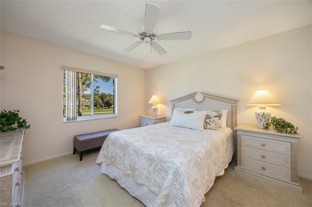 5980 Amherst Drive, Unit D202 Naples, FL 34112 - Photo 8 of 12 Bedroom featuring baseboards, a ceiling fan, and light colored carpet