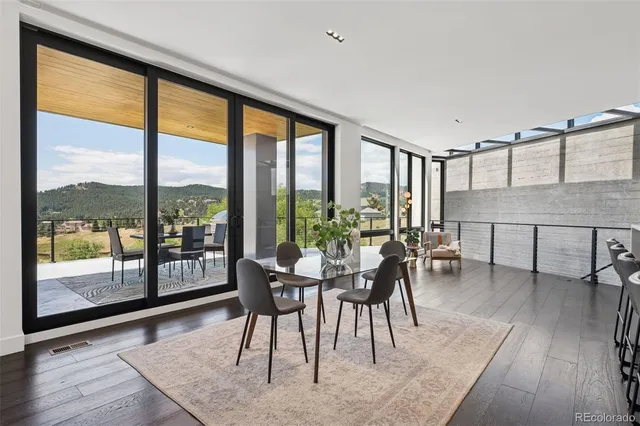a dining room with furniture window and wooden floor