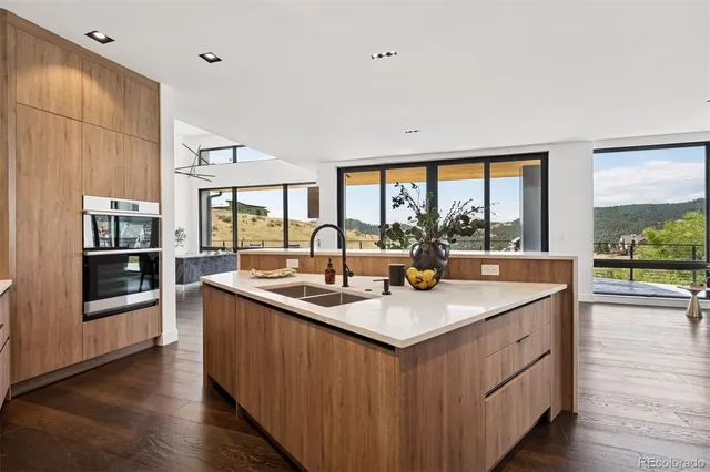 a open kitchen with stainless steel appliances granite countertop a sink and dishwasher with wooden floor
