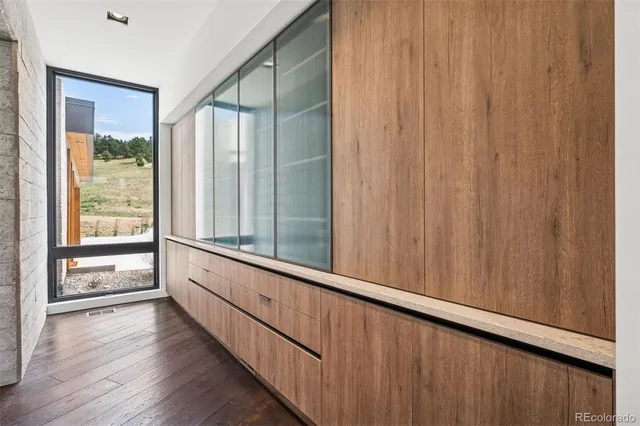 a view of a balcony with wooden floor and iron stairs