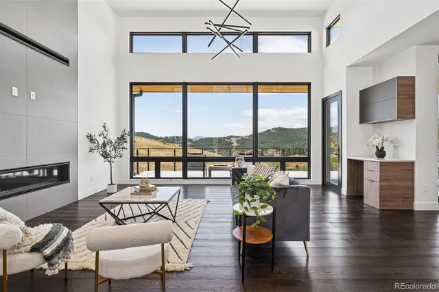 a living room with furniture and floor to ceiling windows