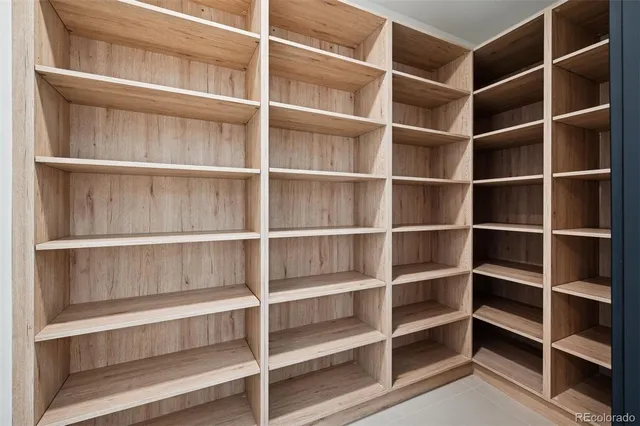 a view of walk in closet with empty racks