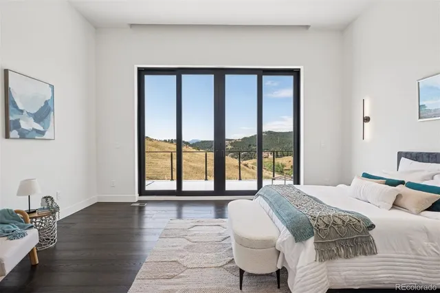 a bedroom with a large bed and a large window