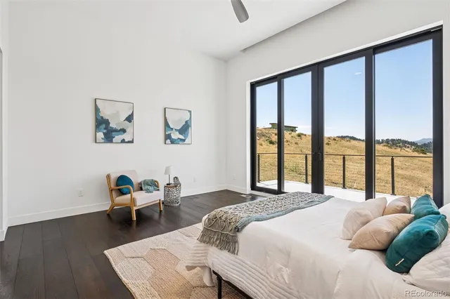 a bedroom with a bed and a large window