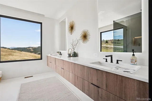 a bathroom with a double vanity sink mirror and a bathtub