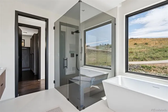 a living room with a large window and a wooden floor