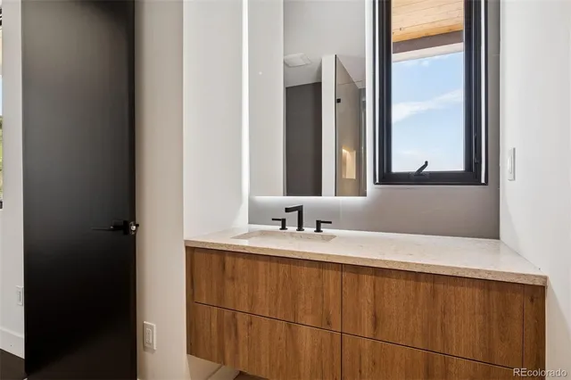 a bathroom with a double vanity sink and a mirror
