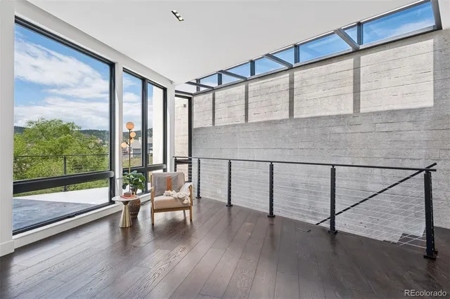 a living room with hardwood floor and windows
