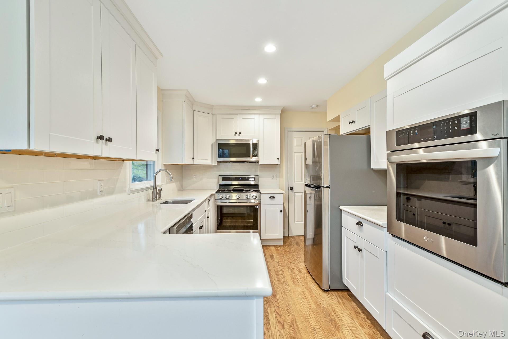 451 River Road Nissequogue, NY 11780 - Photo 11 of 24 a kitchen with cabinets and stainless steel appliances