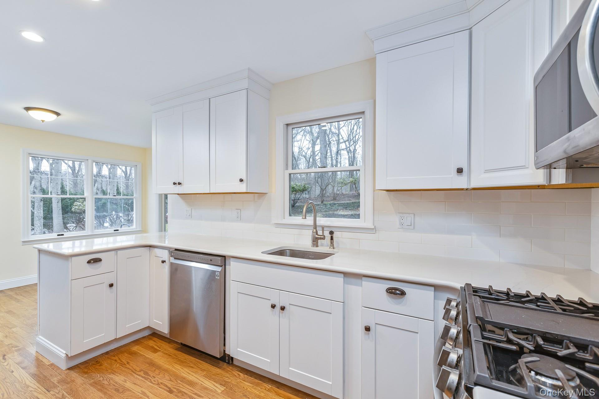 451 River Road Nissequogue, NY 11780 - Photo 12 of 24 a kitchen with a sink stove and cabinets
