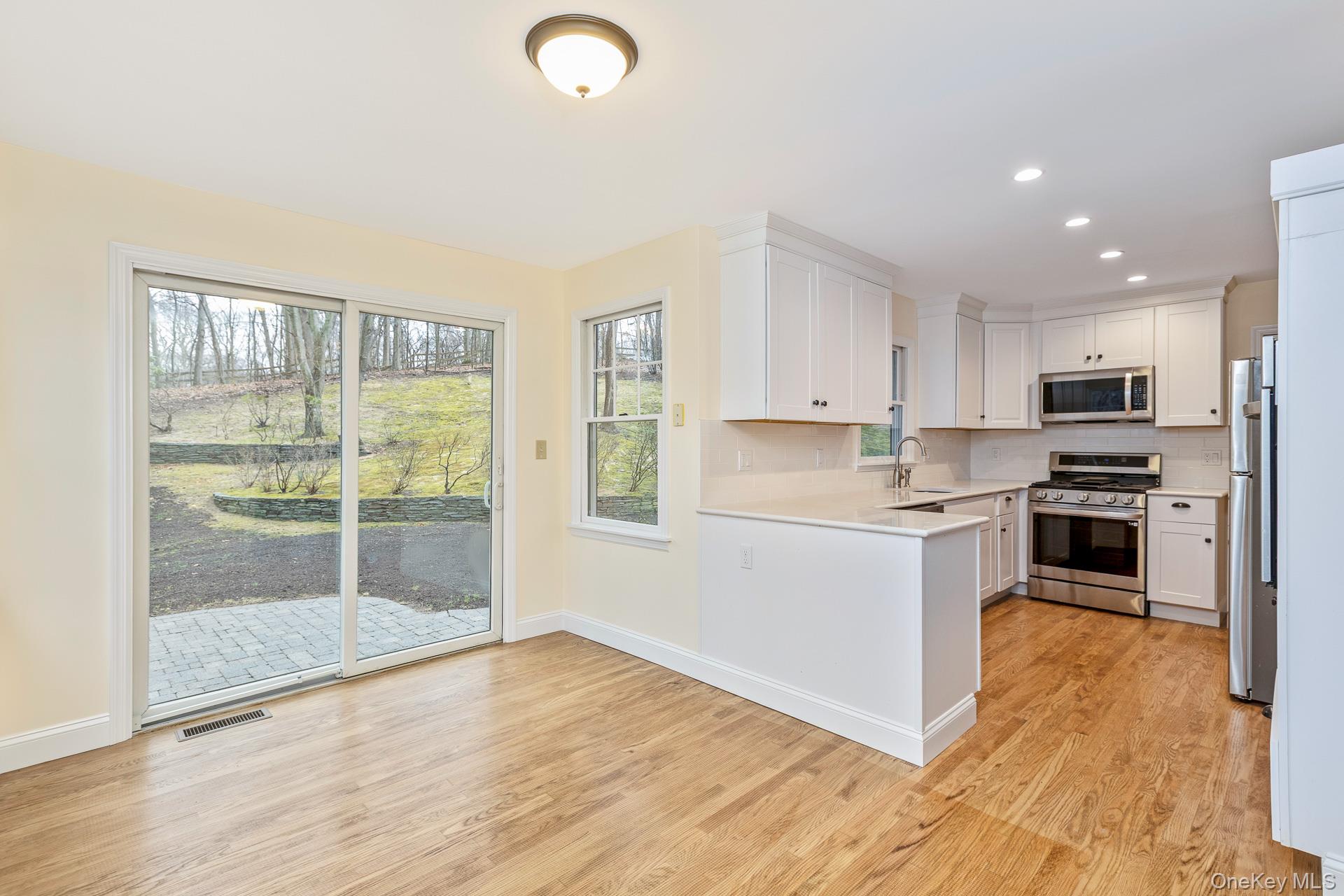 451 River Road Nissequogue, NY 11780 - Photo 13 of 24 a kitchen with granite countertop a refrigerator and a stove top oven