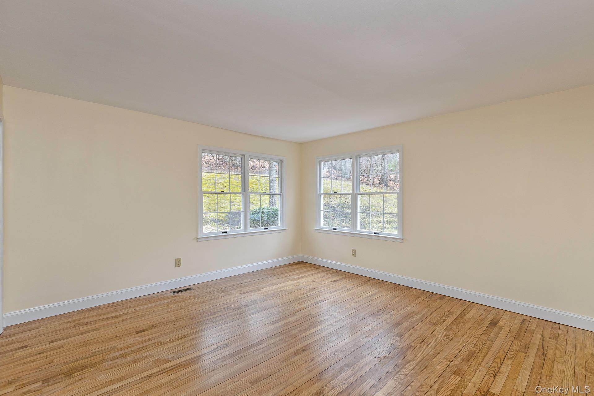 451 River Road Nissequogue, NY 11780 - Photo 15 of 24 an empty room with wooden floor and windows