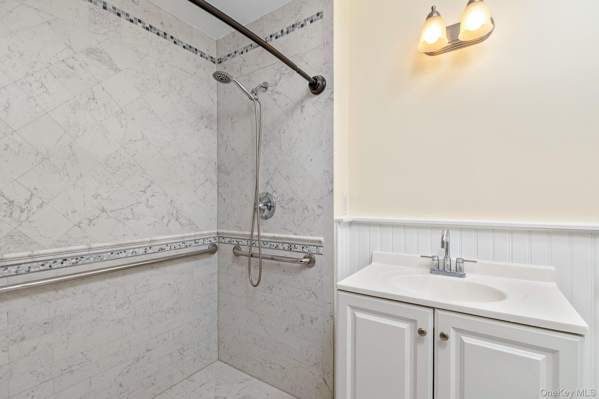 451 River Road Nissequogue, NY 11780 - Photo 17 of 24 a bathroom with a sink a vanity and a shower