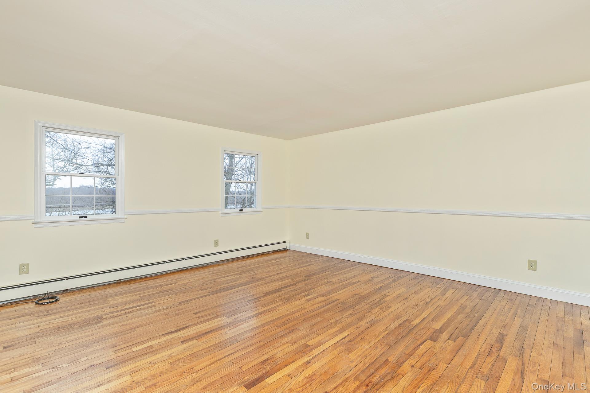 451 River Road Nissequogue, NY 11780 - Photo 18 of 24 an empty room with wooden floor and windows
