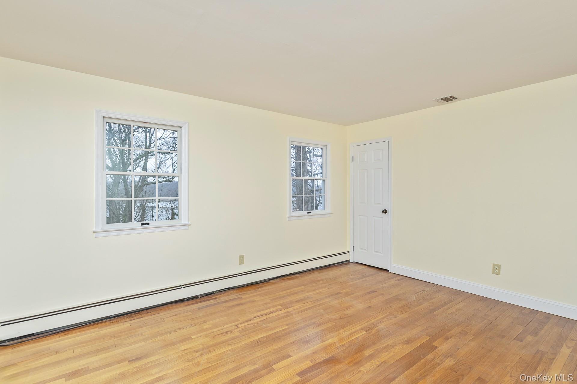 451 River Road Nissequogue, NY 11780 - Photo 22 of 24 a view of an empty room with wooden floor and a window