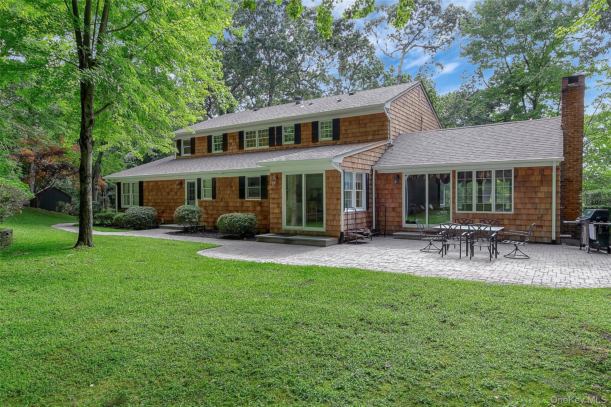 451 River Road Nissequogue, NY 11780 - Photo 23 of 24 a view of a house with a backyard and a patio