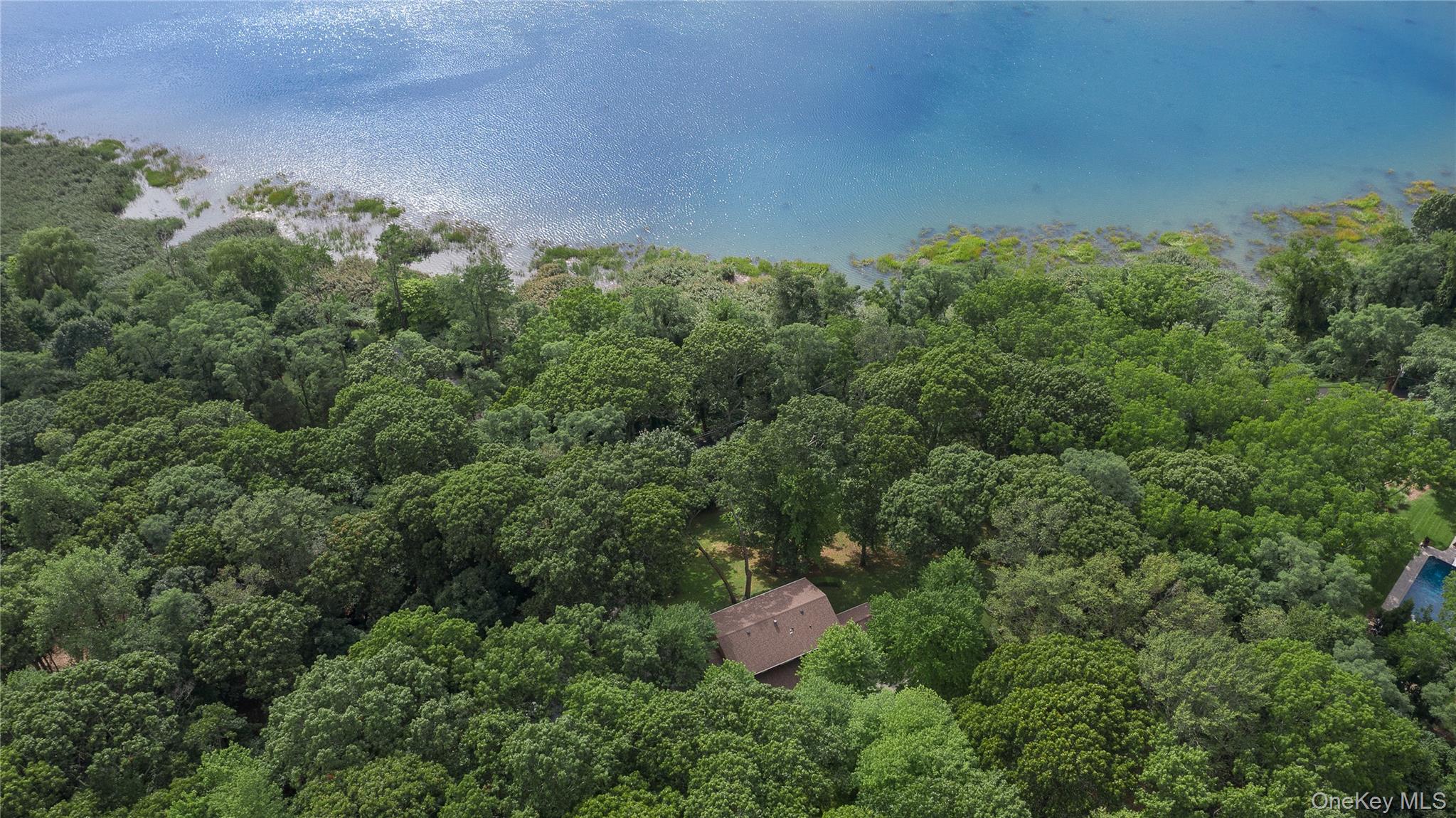 451 River Road Nissequogue, NY 11780 - Photo 3 of 24 an aerial view of residential house with outdoor space and trees all around