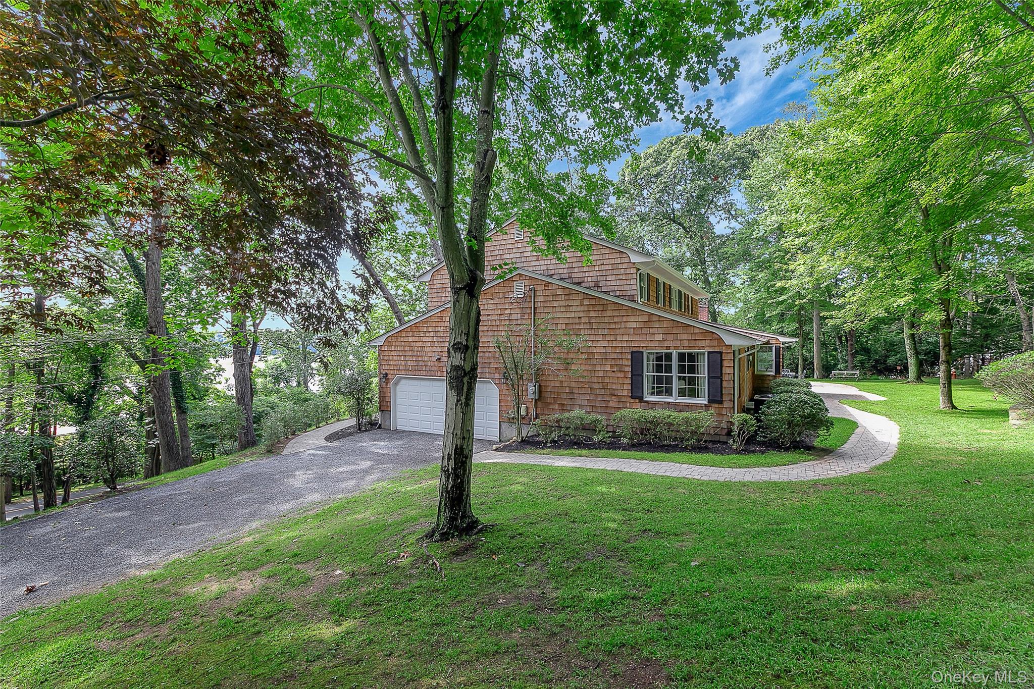 451 River Road Nissequogue, NY 11780 - Photo 4 of 24 a backyard of a house with plants and large tree