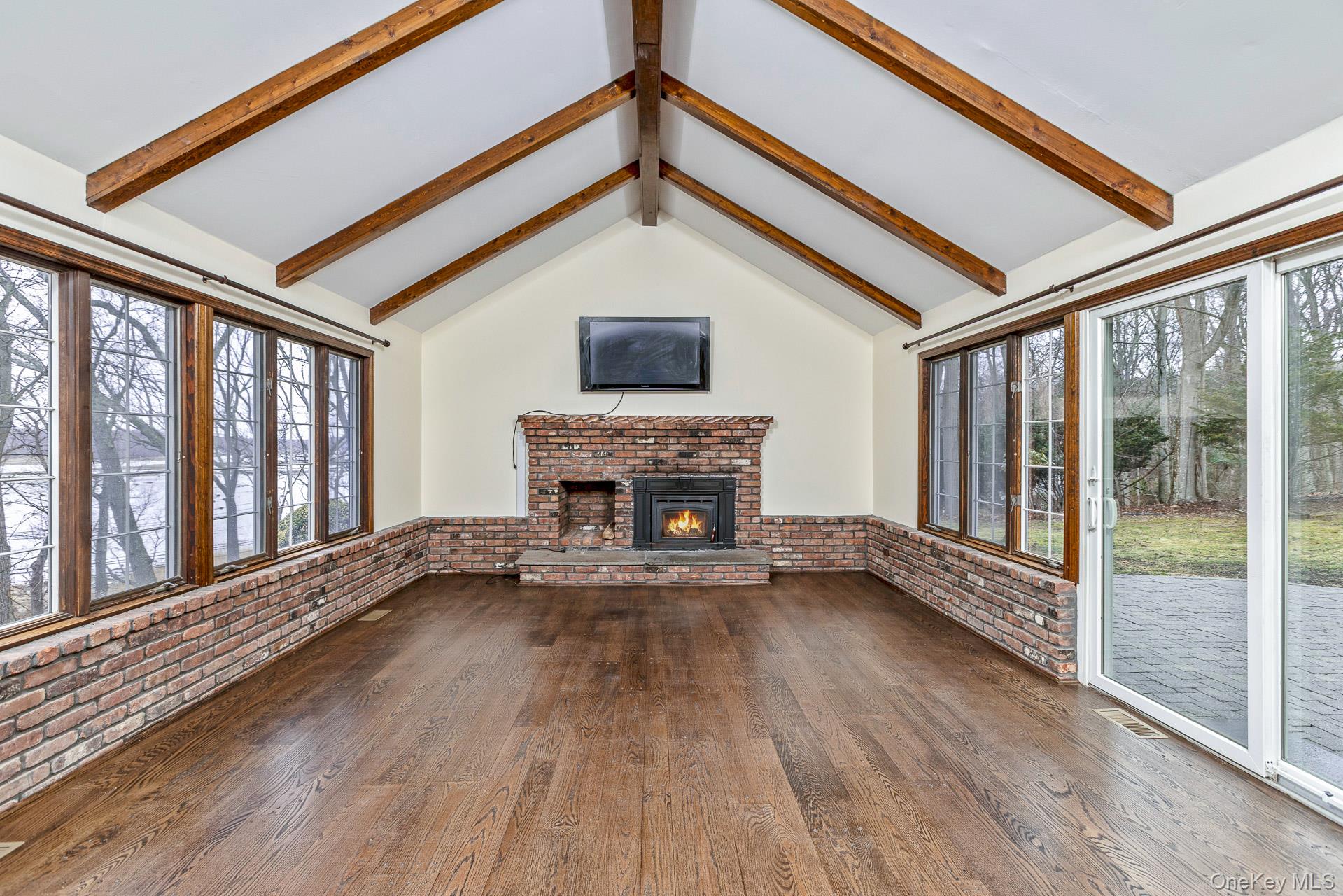 451 River Road Nissequogue, NY 11780 - Photo 9 of 24 a view of an empty room with wooden floor and a window