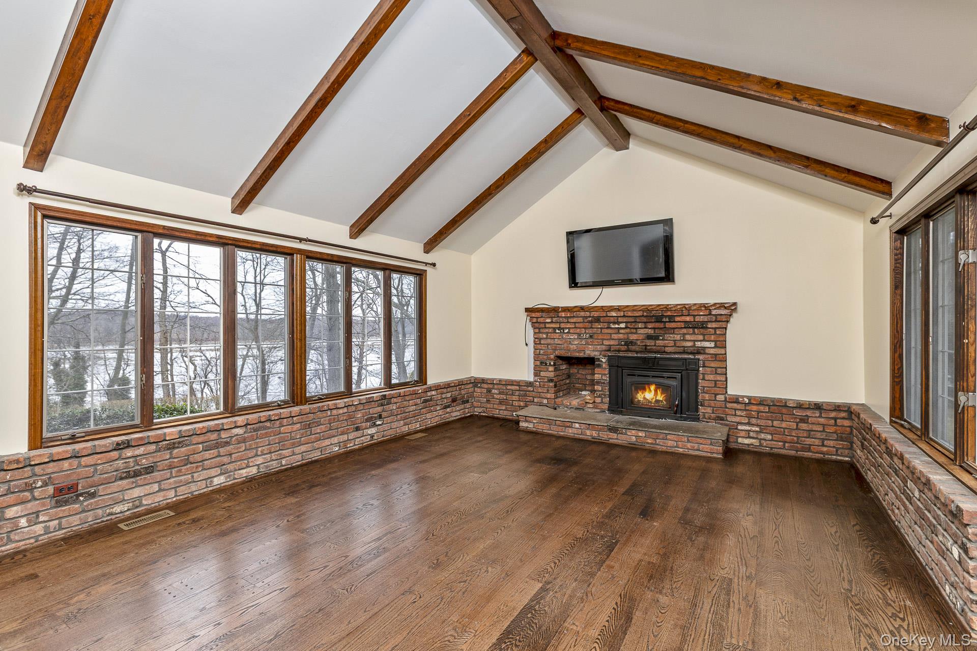 451 River Road Nissequogue, NY 11780 - Photo 10 of 24 a view of an empty room with wooden floor and a window