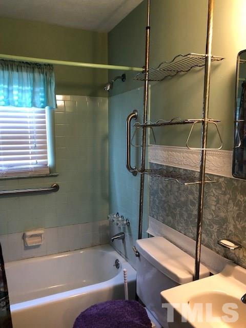 920 Seabrook Road Raleigh, NC 27610 - Photo 2 of 9 a bathroom with a bathtub and a shower
