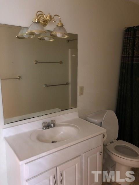 920 Seabrook Road Raleigh, NC 27610 - Photo 4 of 9 a bathroom with a sink toilet and mirror