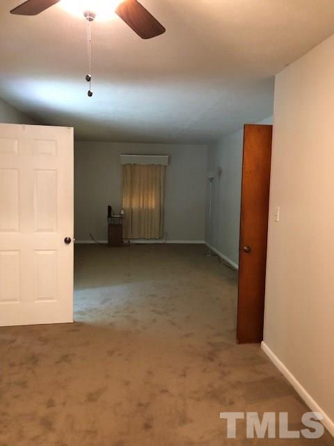 920 Seabrook Road Raleigh, NC 27610 - Photo 8 of 9 en empty room with windows and cabinet