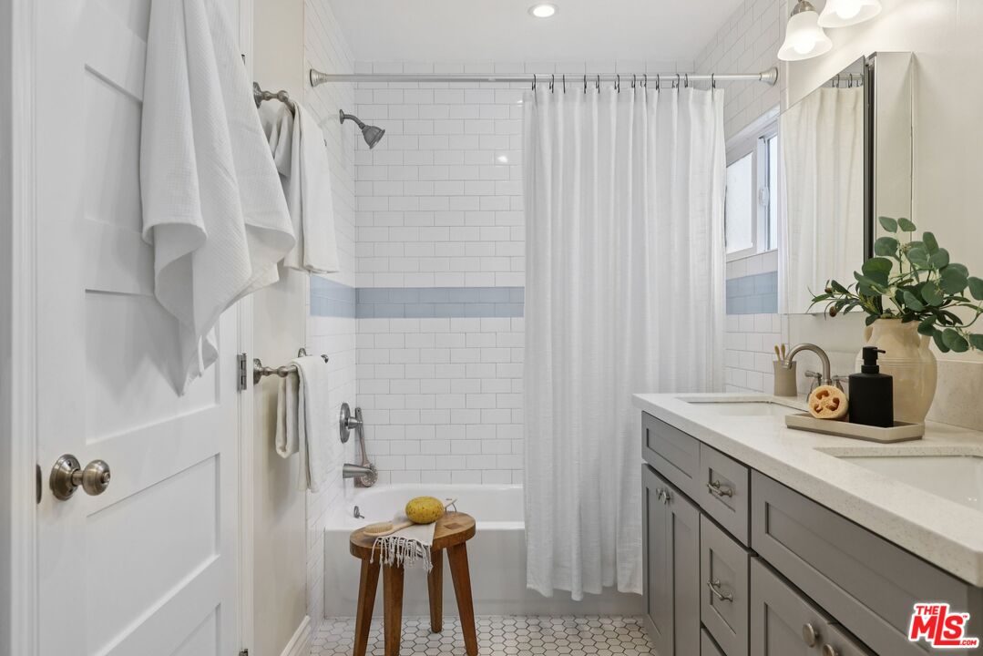 706 Isabel Street Los Angeles, CA 90065 - Photo 12 of 20 a bathroom with a shower curtain and a sink