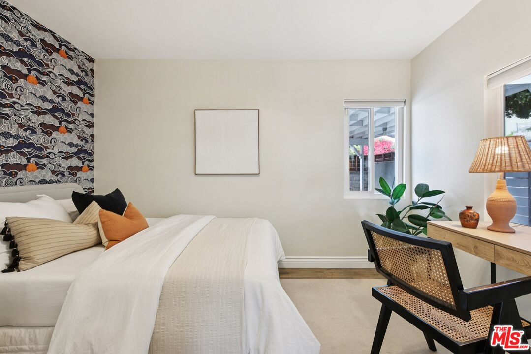 706 Isabel Street Los Angeles, CA 90065 - Photo 14 of 20 a bedroom with a bed and a table in it