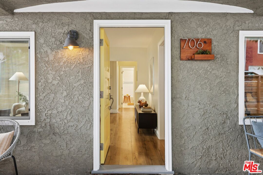 706 Isabel Street Los Angeles, CA 90065 - Photo 3 of 20 a view of a hallway with wooden floor and a living room