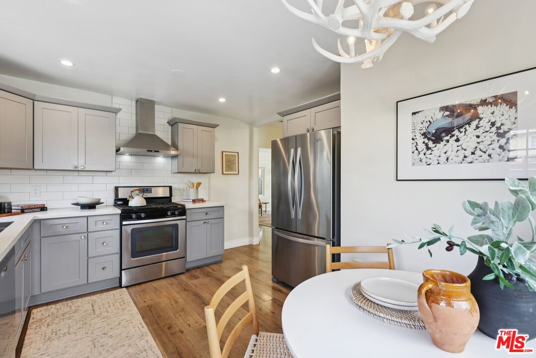 706 Isabel Street Los Angeles, CA 90065 - Photo 7 of 20 a kitchen with stainless steel appliances granite countertop a refrigerator a stove a sink and white cabinets