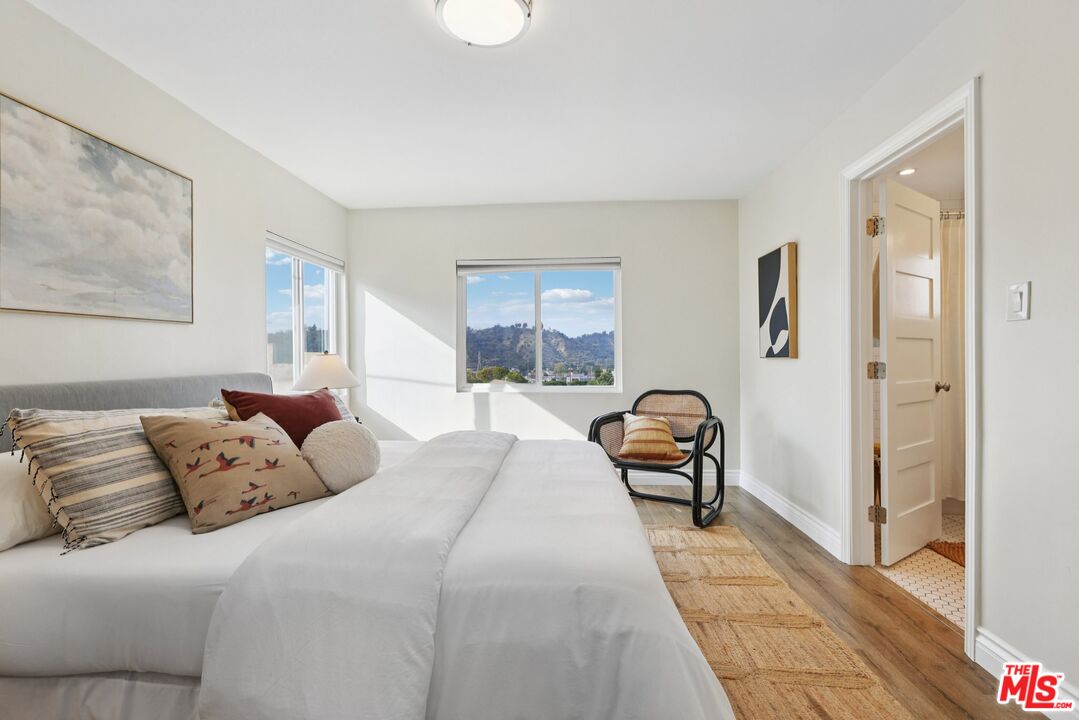 706 Isabel Street Los Angeles, CA 90065 - Photo 9 of 20 a bedroom with a bed and a painting on the wall