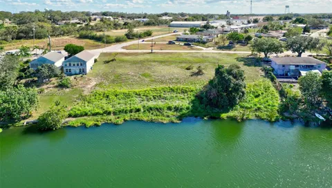 an aerial view of a houses with a lake view