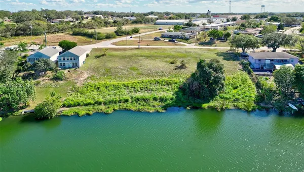 an aerial view of a houses with a lake view