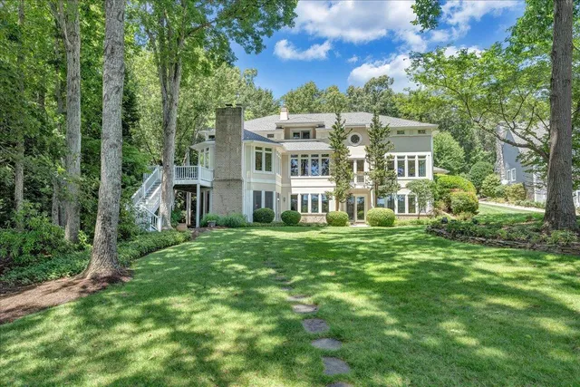 an empty room with windows and fireplace