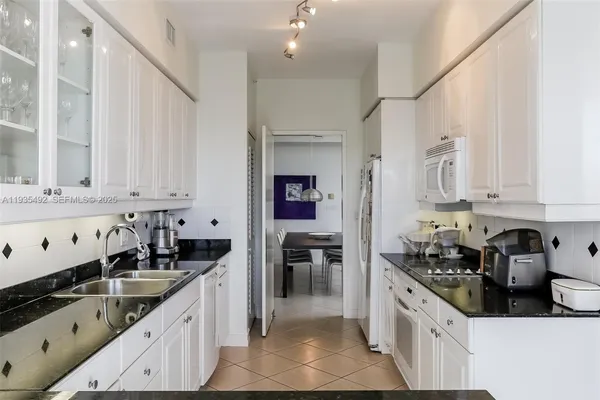 a kitchen with stainless steel appliances a sink stove and cabinets