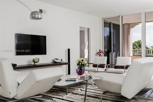 a living room with a flat screen tv and a large window