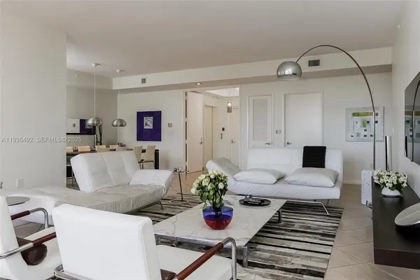 a living room with furniture and flowers