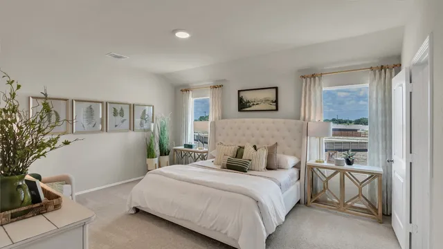 a bedroom with a bed and a potted plant