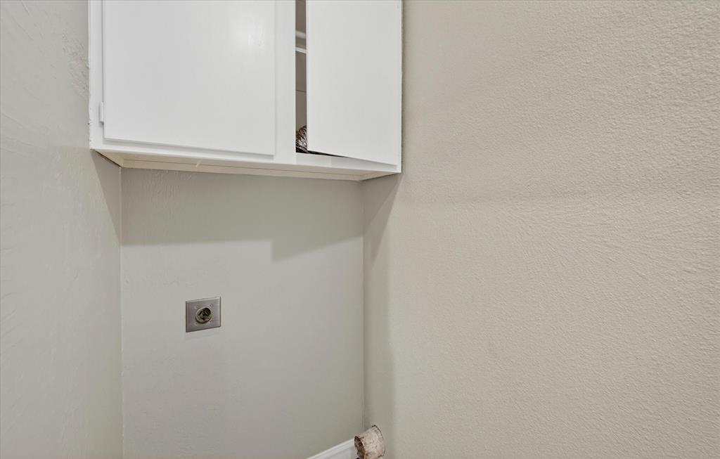 9809 Matchpoint Place Dallas, TX 75243 - Photo 12 of 21 White upper cabinetry providing storage