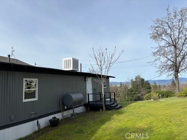 a backyard of a house with table and chairs