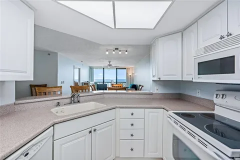 a kitchen with cabinets stainless steel appliances and a sink