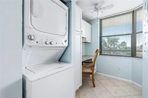 a view of washer and dryer with bathroom in the background