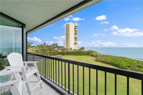 a view of a balcony with wooden floor