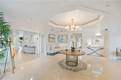 a living room with fireplace furniture and a chandelier