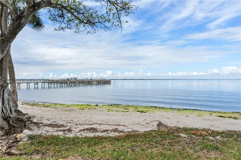 a view of a large body of water with a building in the background