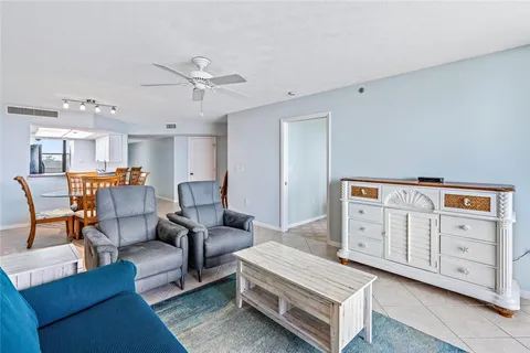 a living room with furniture and kitchen view