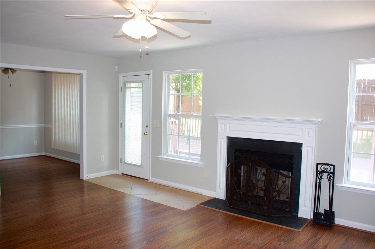 1515 Pebble Ridge Drive Raleigh, NC 27610 - Photo 10 of 17 Large, open family room with woodburning fireplace, and french door leading out to the deck and fenced yard. Open to the dining room and kitchen area with bar space. Family Room