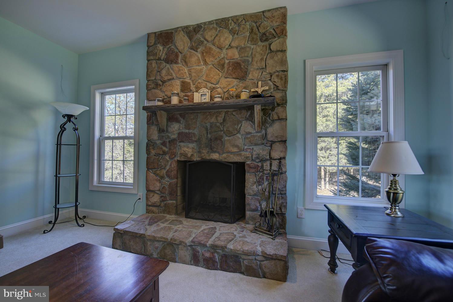 Living Room with Wood Burning, Stone Fireplace